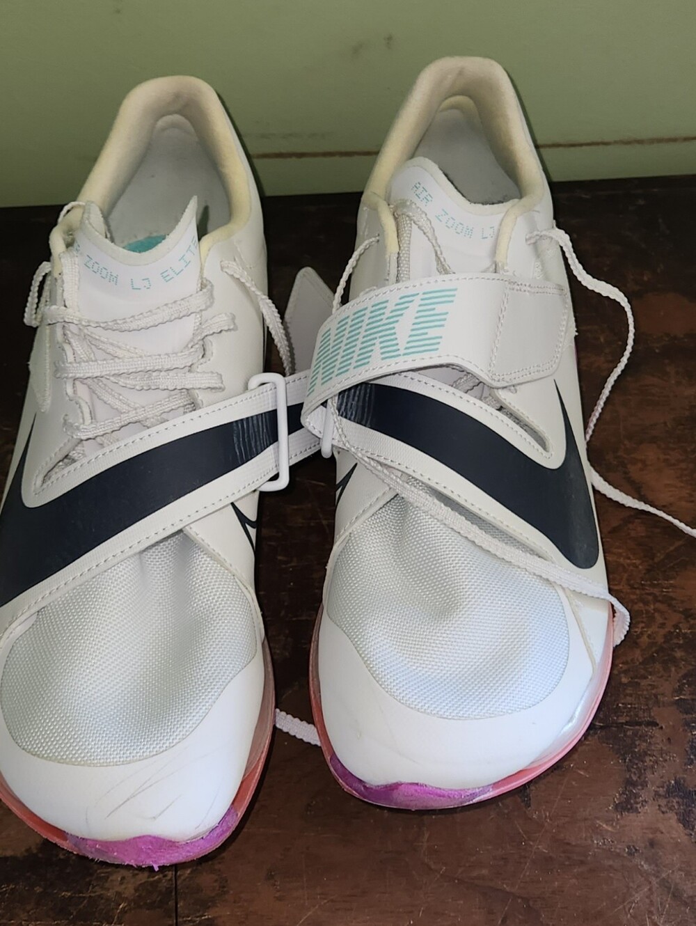Men's Nike White Track Spikes with Black Swoosh and Pink Toe Accents